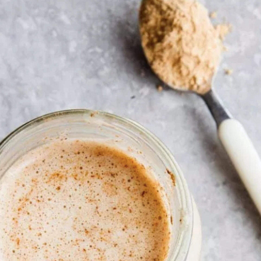 Spoonful of powder over a creamy drink