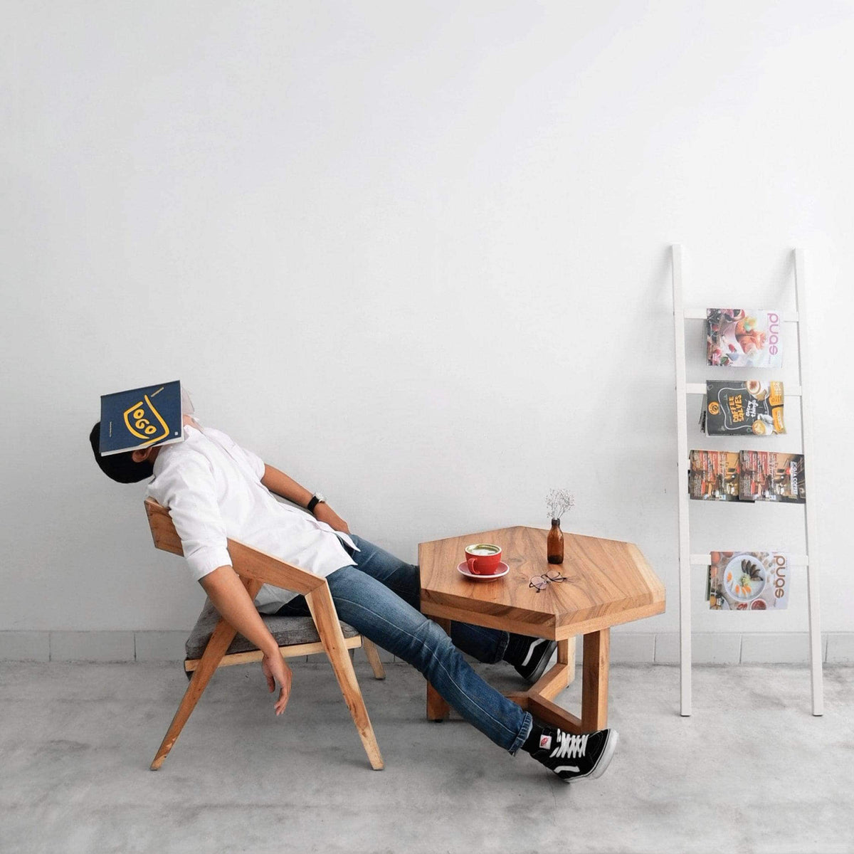 Man dozing in a chair with a book over his face