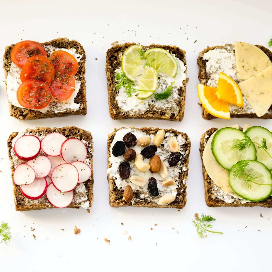 Six open sandwiches on rye bread with different toppings