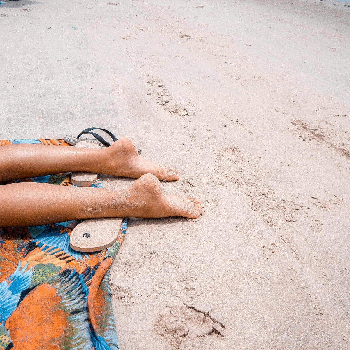 Person sitting on a sandy beach