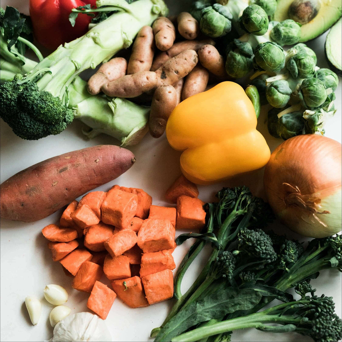 Fresh vegetables including broccoli, sweet potato and peppers