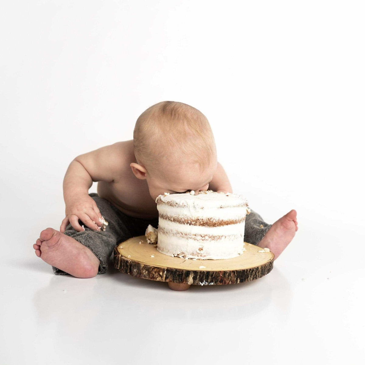 Baby eating a cake with its face