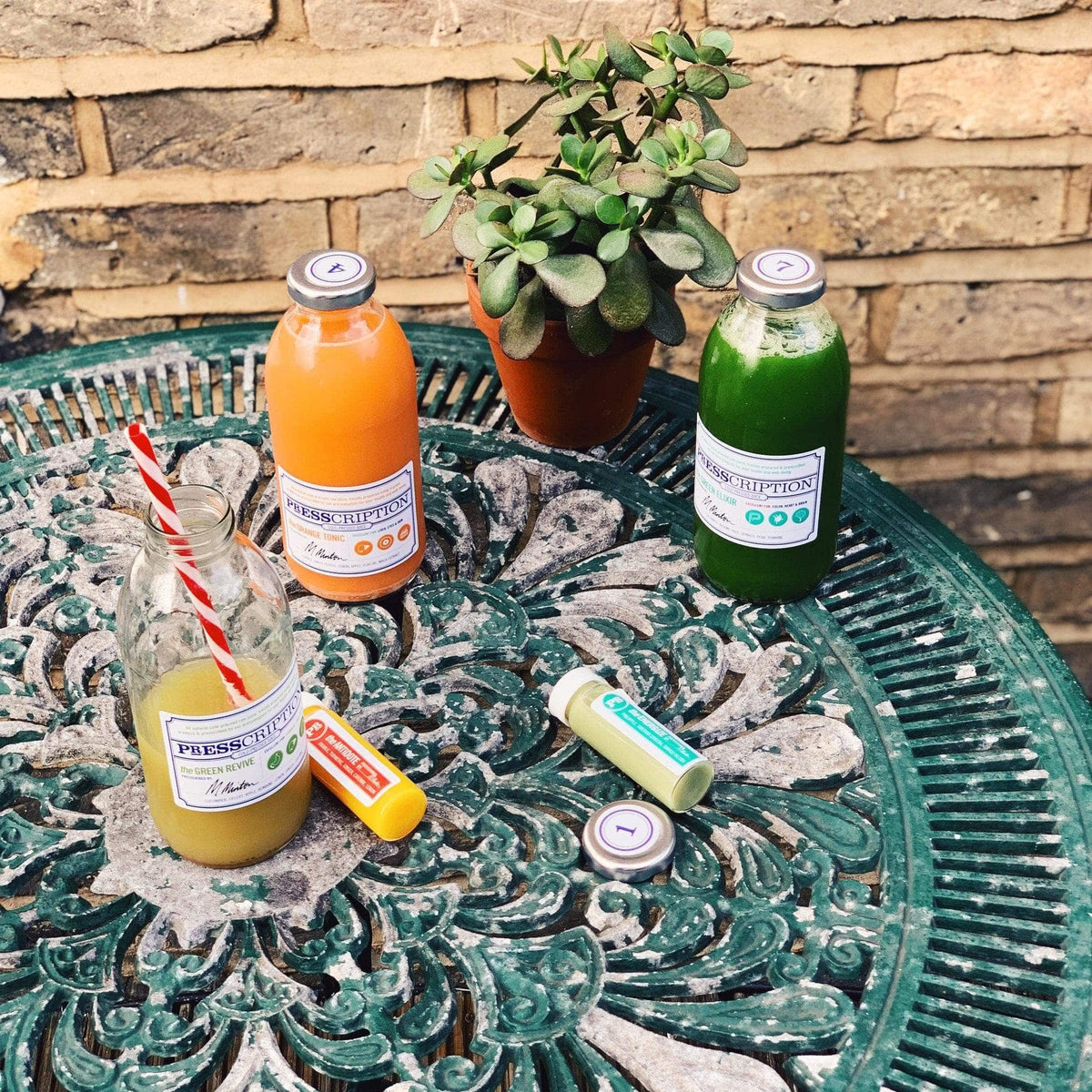 Presscription juices and shots on a garden table