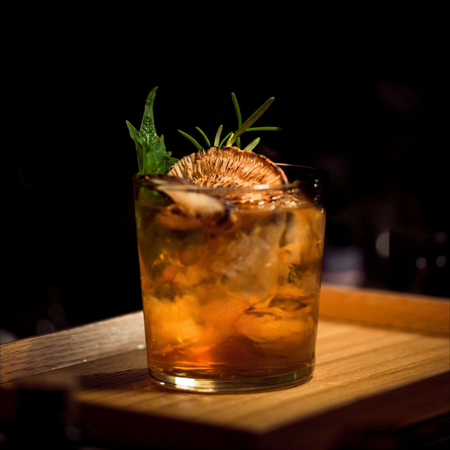 Cocktail with a garnish on a wooden board
