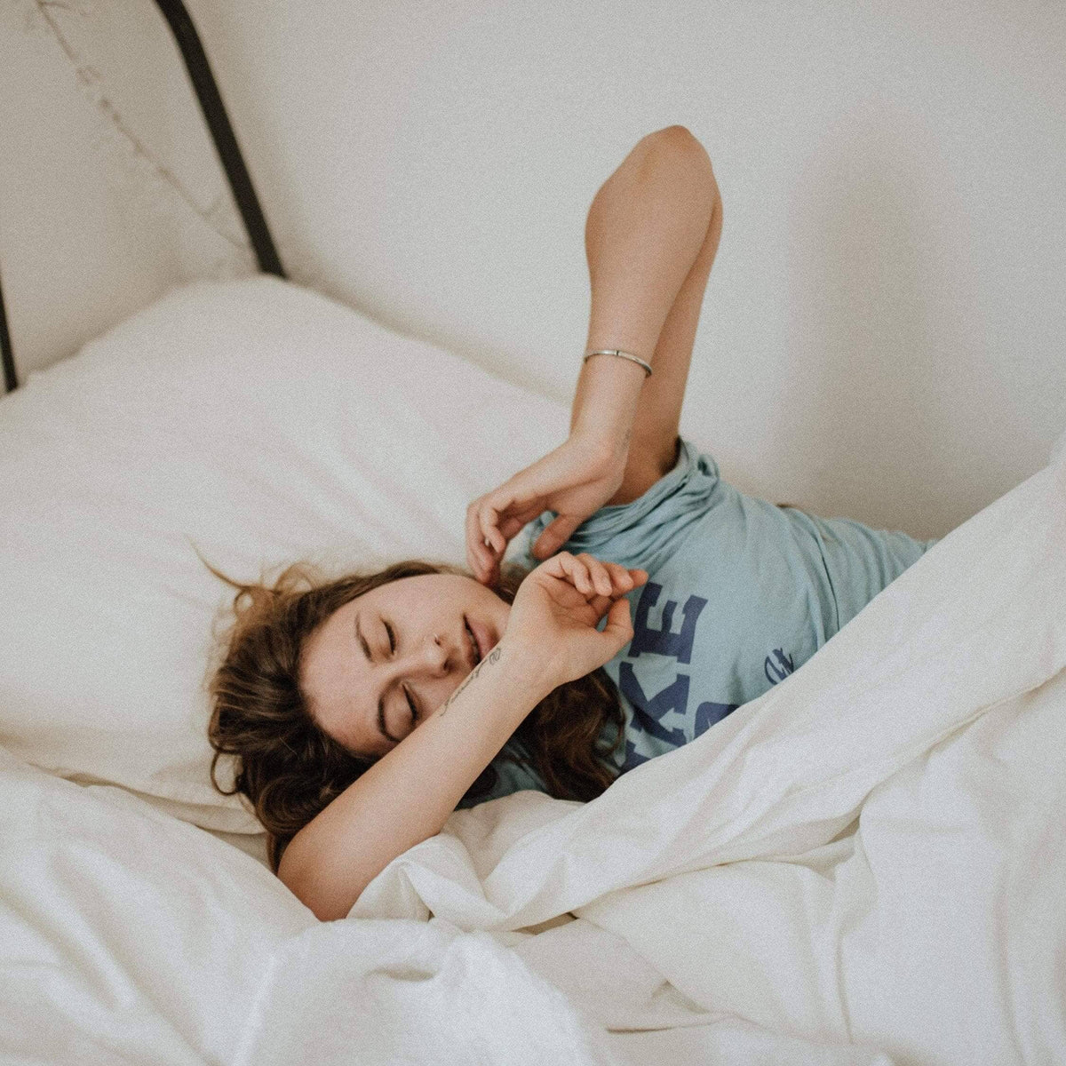 Woman stretching and yawning in bed