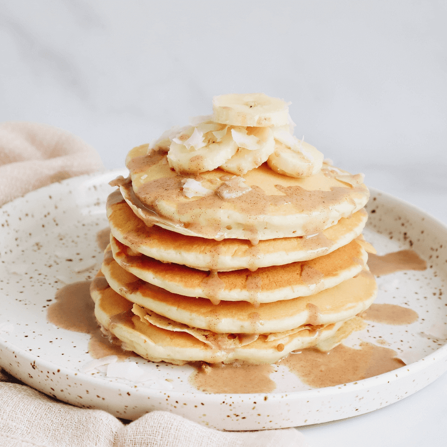 Stack of pancakes topped with banana