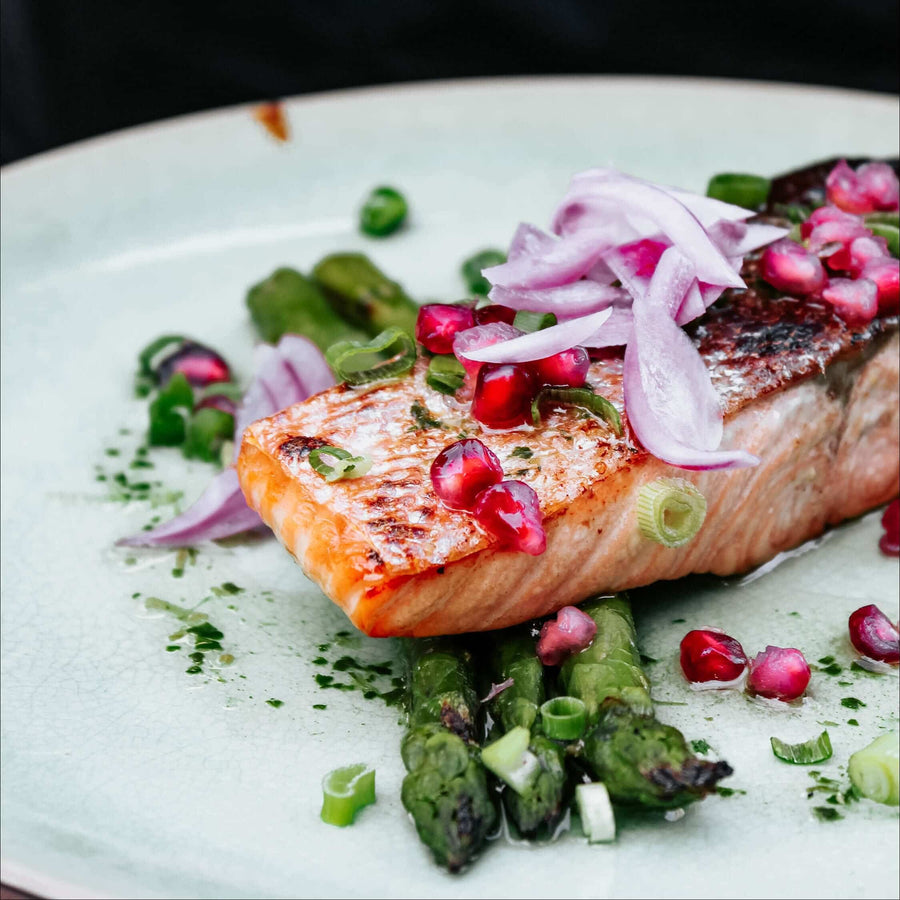 Salmon fillet with asparagus, red onion and pomegranate