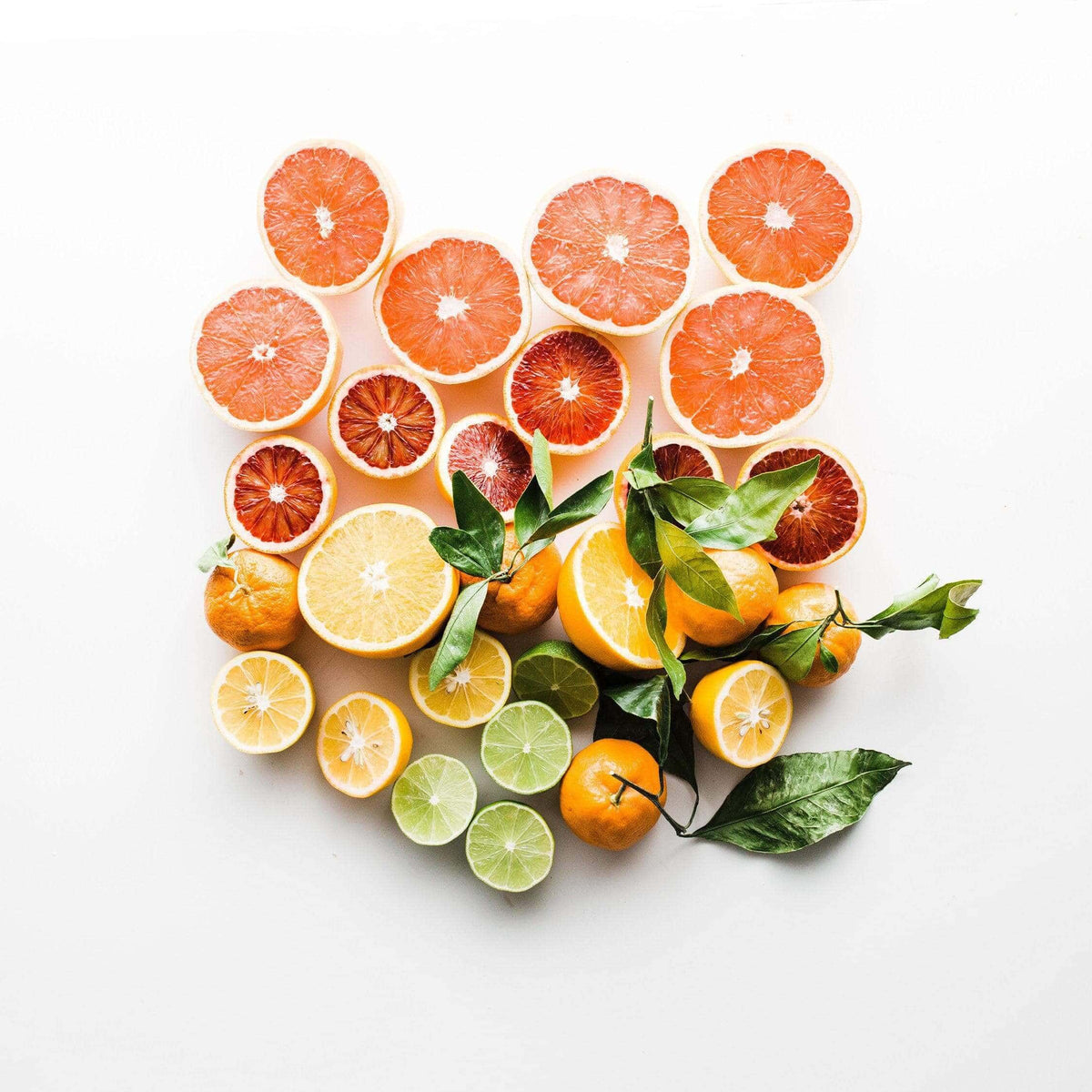 Sliced citrus fruit arranged on a white background